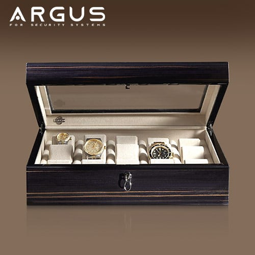 Luxury automatic wristwatches arranged on a dark surface, the kind of collection a watch winder safe is built to hold